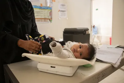 Baby being weighed